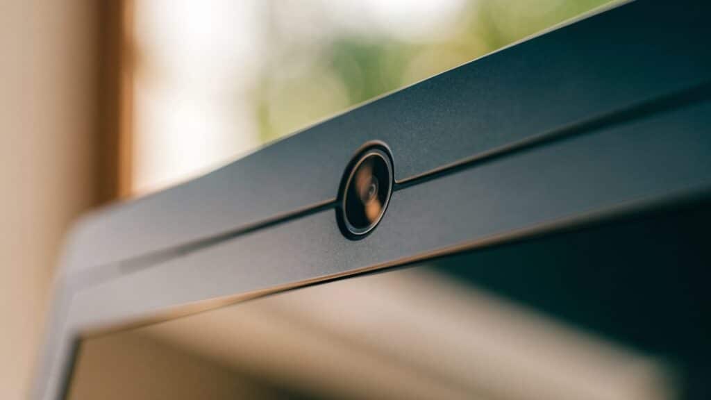 Macro close-up of the webcam above the screen of a graphite black laptop