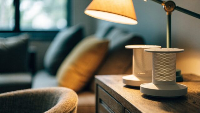 Two mesh wifi units on a sideboard in a cozy living room