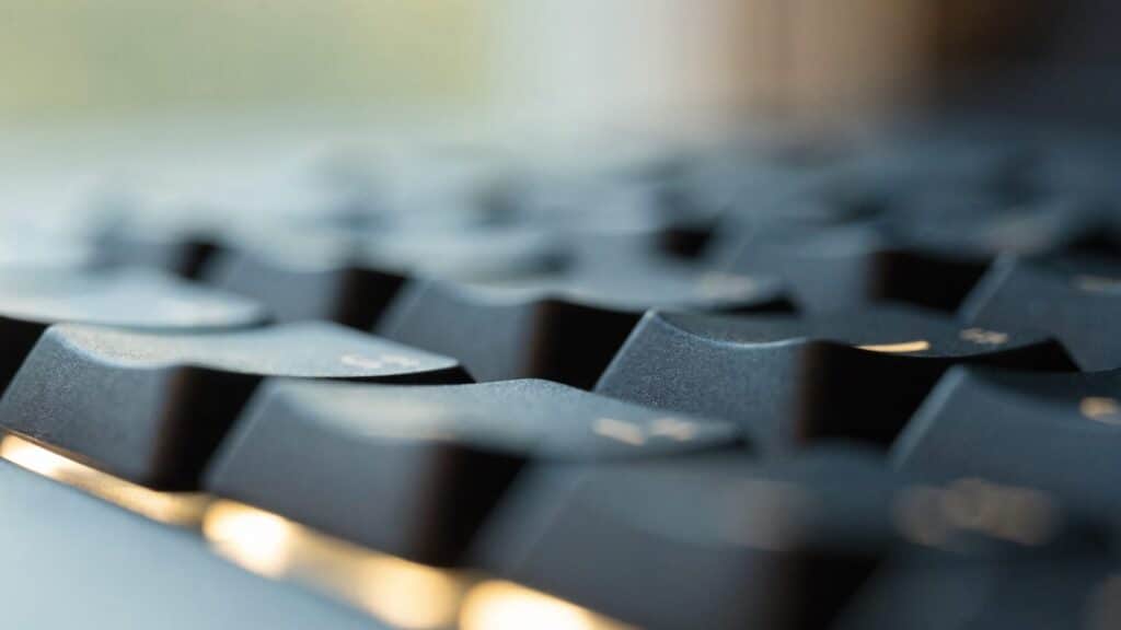 Macro close-up of backlit keys on a graphite black laptop keyboard