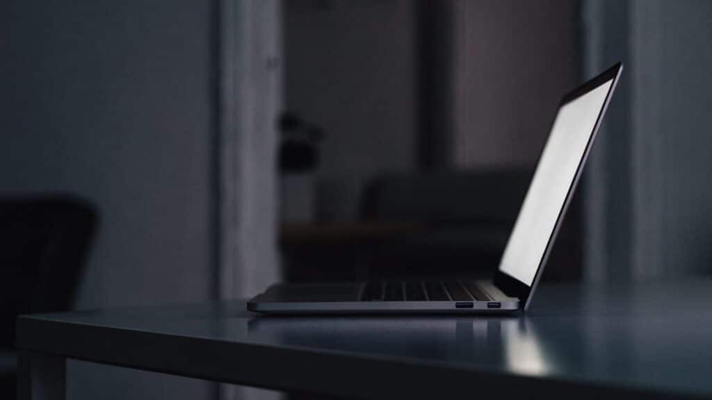 A matte grey laptop in a dark room