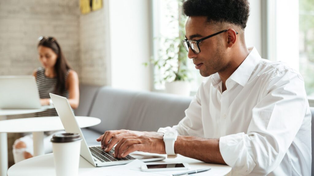 Concentrated young african man sitting coworking