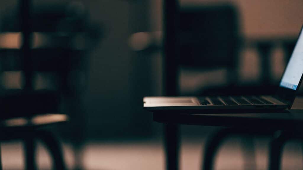 A matte grey laptop in a dark room