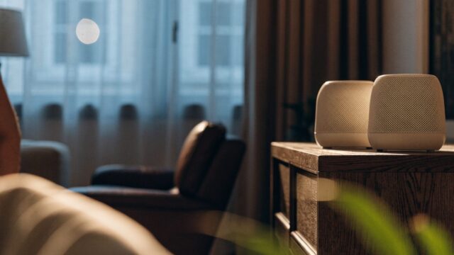 Two mesh wifi units on a sideboard in a cozy living room
