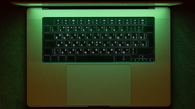 Laptop in green neon for coding and data eco tech work