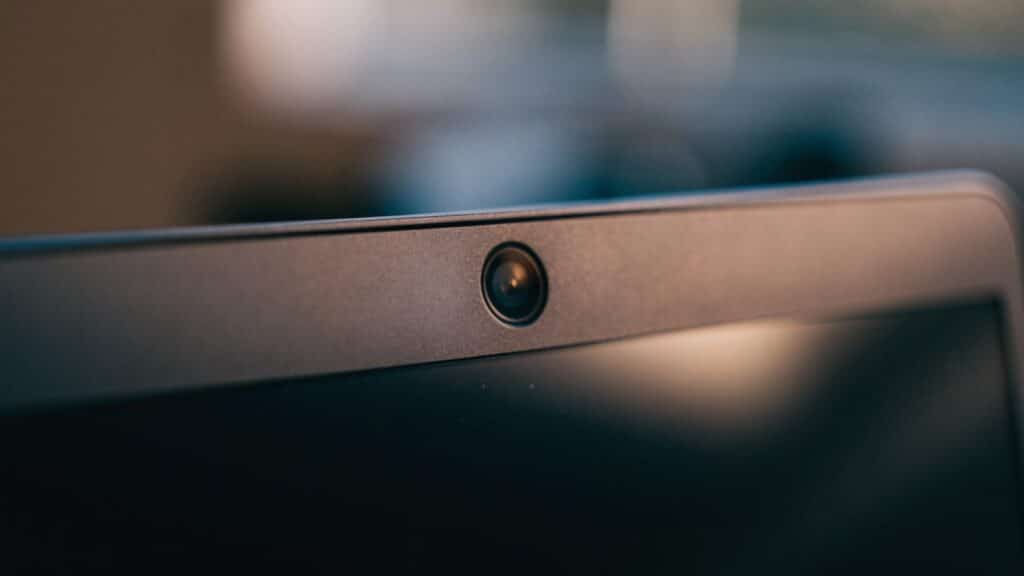 Macro close-up of the webcam above the screen of a graphite black laptop