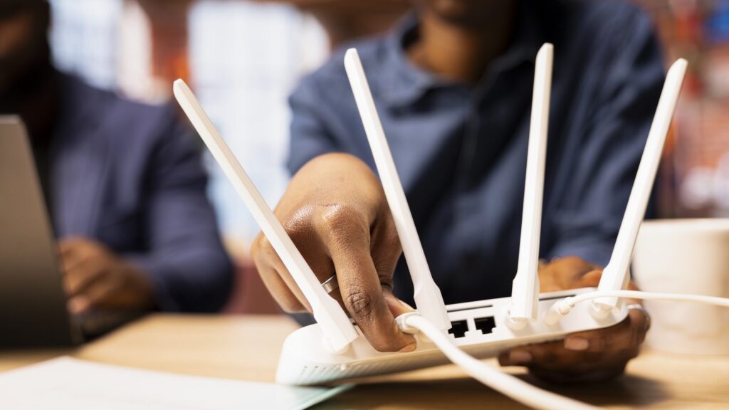 Black couple at home examine the modem setup and troubleshooting online guides