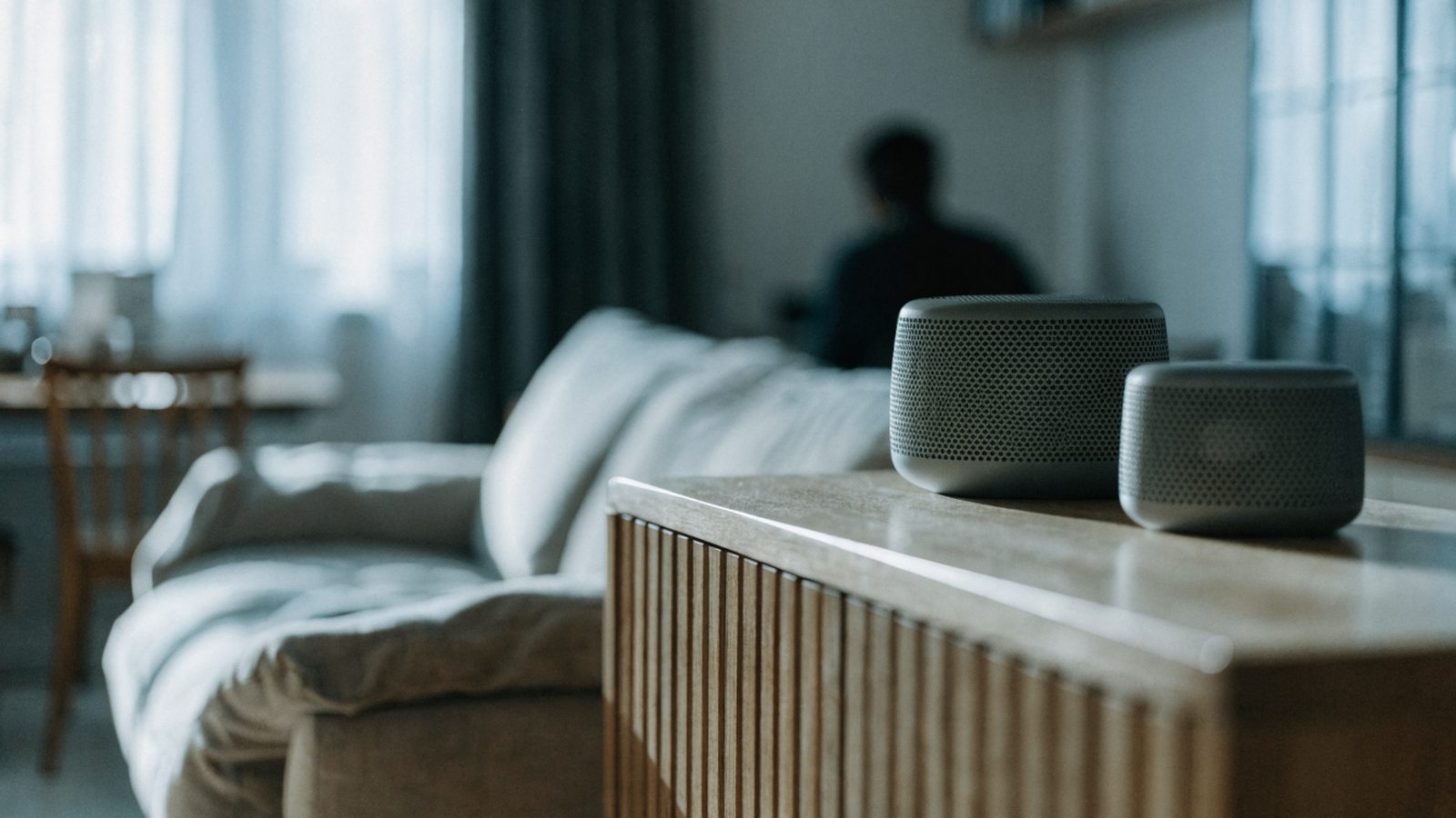 Two mesh wifi units on a sideboard in a cozy living room