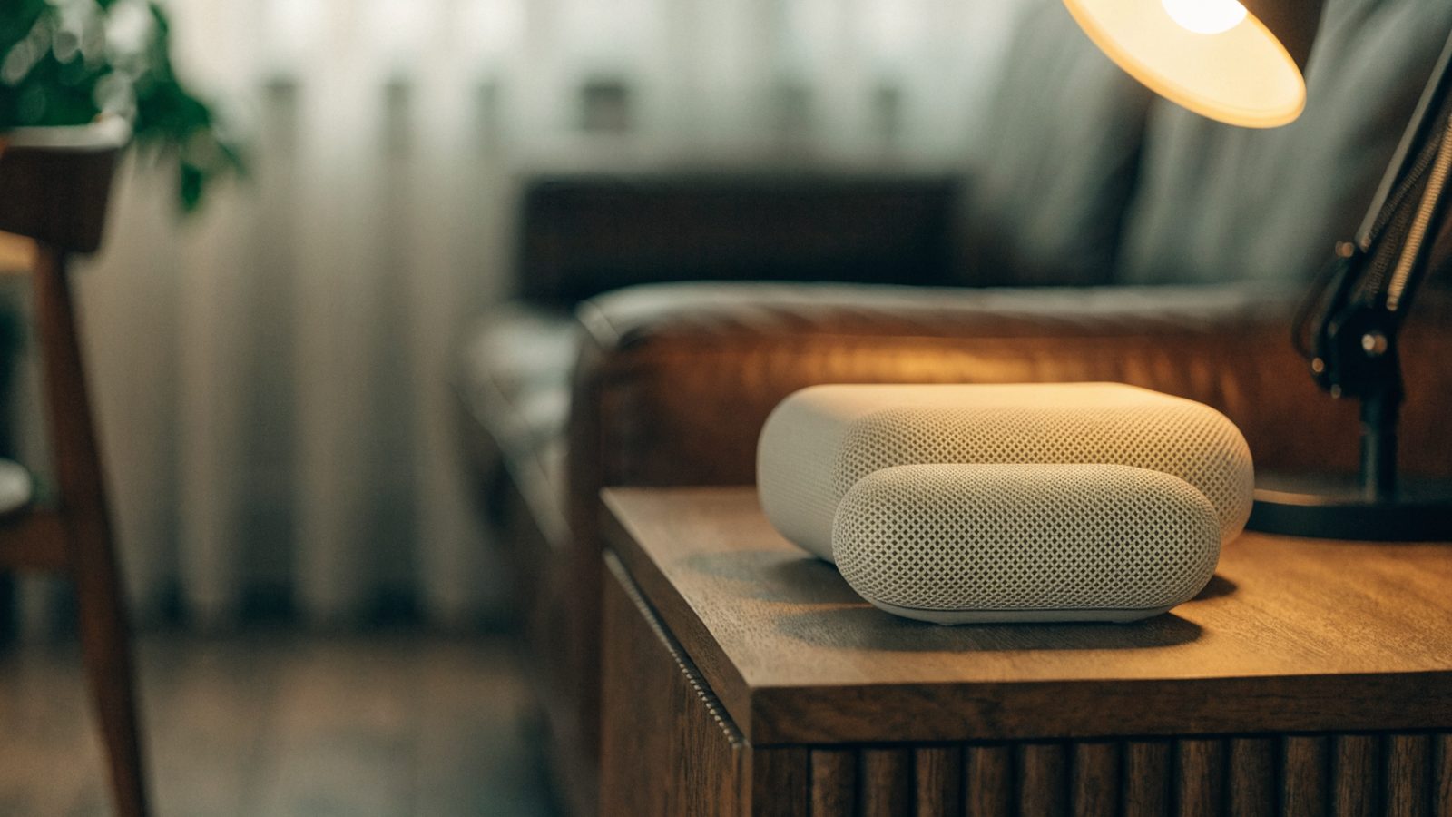 Two mesh wifi units on a sideboard in a cozy living room