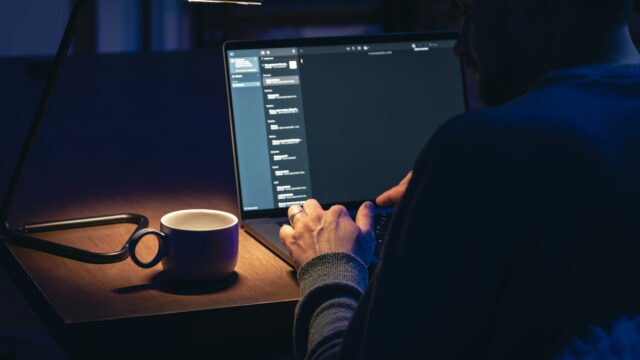 Dedicated businessman working late at laptop in dark office