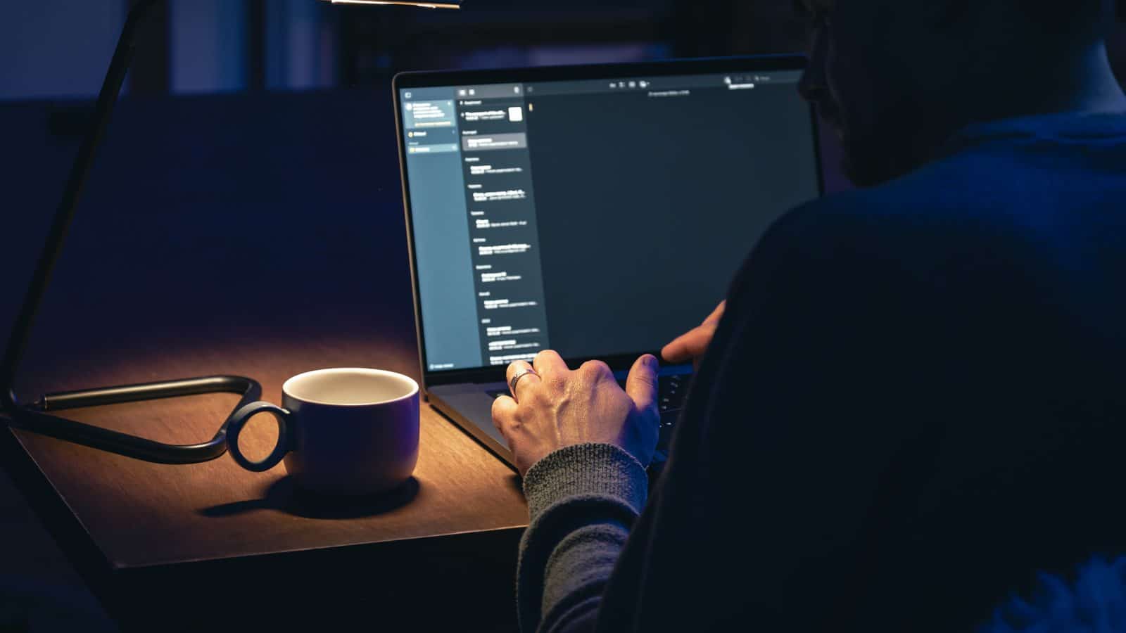 Dedicated businessman working late at laptop in dark office