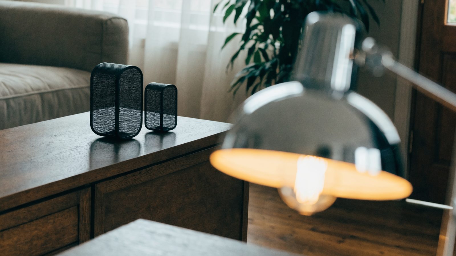 Two mesh wifi units on a sideboard in a cozy living room