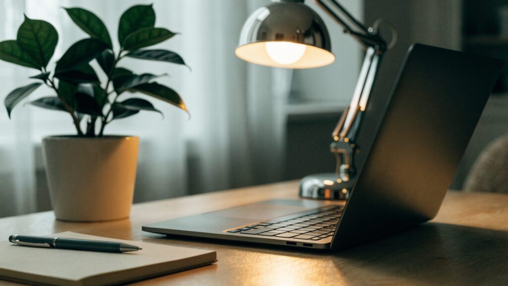 A tidy home office desk with a graphite black laptop