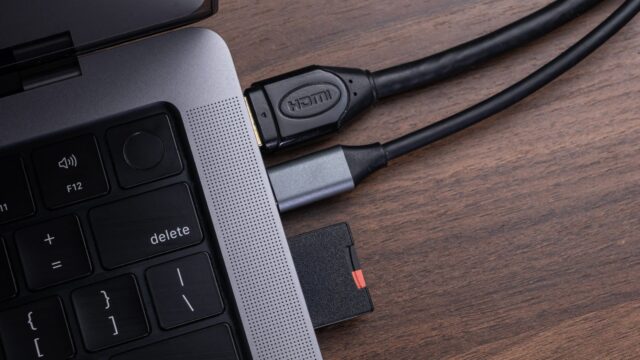 Modern laptop connected to an HDMI cable and an SD card via a versatile multiport USBC hub for enhanced…