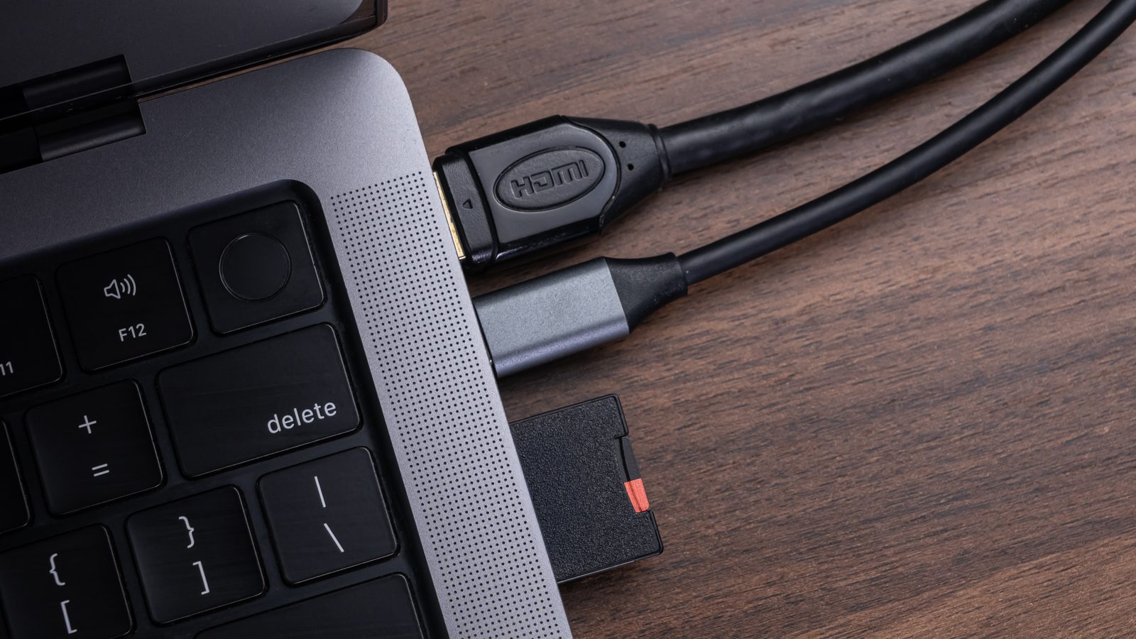 Modern laptop connected to an HDMI cable and an SD card via a versatile multiport USBC hub for enhanced…