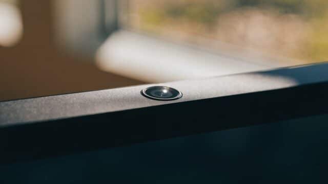Macro close-up of the webcam above the screen of a graphite black laptop
