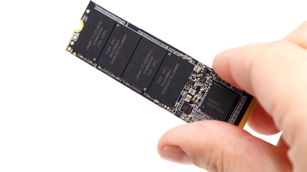 Caucasian hand holding NonVolatile Memory Next Generation Form Factor solid state drive 2280 3Dnand…
