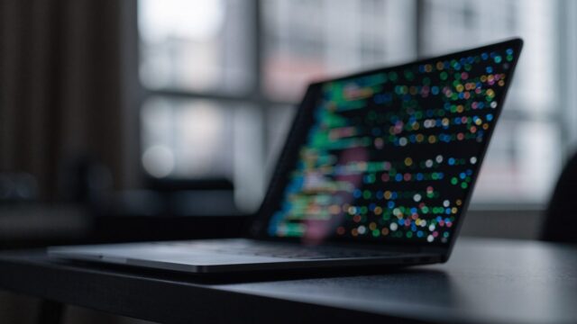 A matte grey laptop in a dim room
