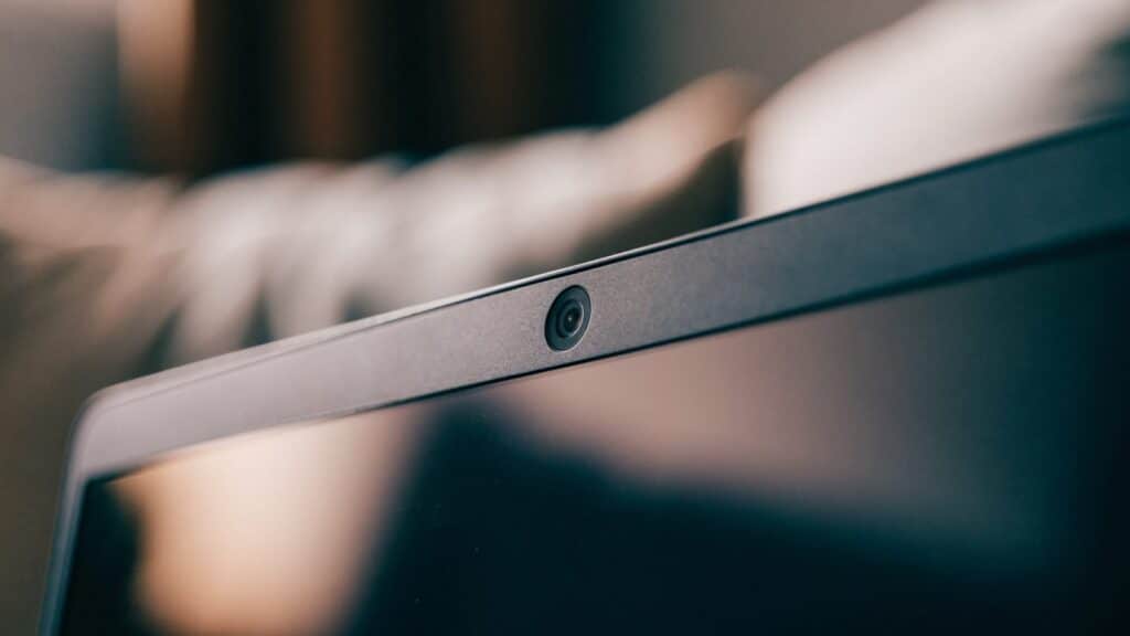 Macro close-up of the webcam above the screen of a graphite black laptop