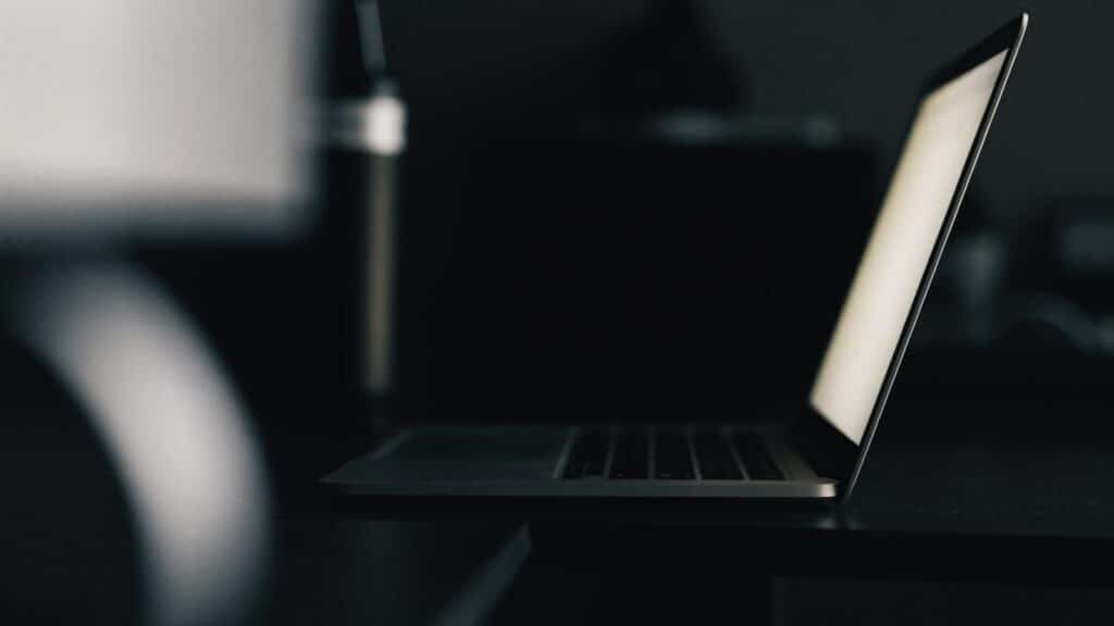 A matte grey laptop in a dark room